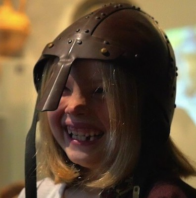 Child wearing a Roman Helmet